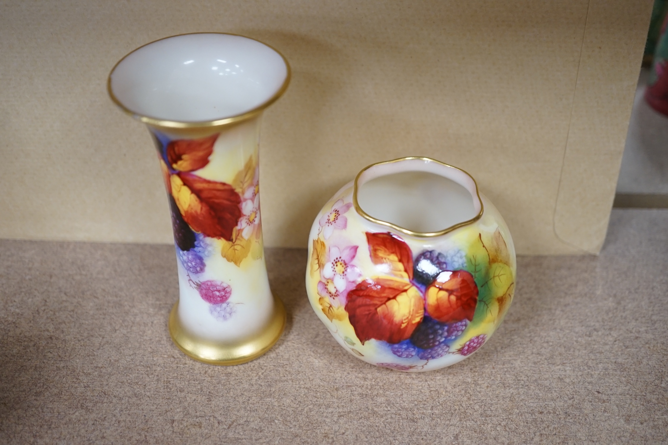 A Royal Worcester spill vase fruit painted with berries by Kitty Blake and a small bowl by the same artist, largest 11.5cm high. Condition - good